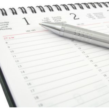 Open planner with a pen
