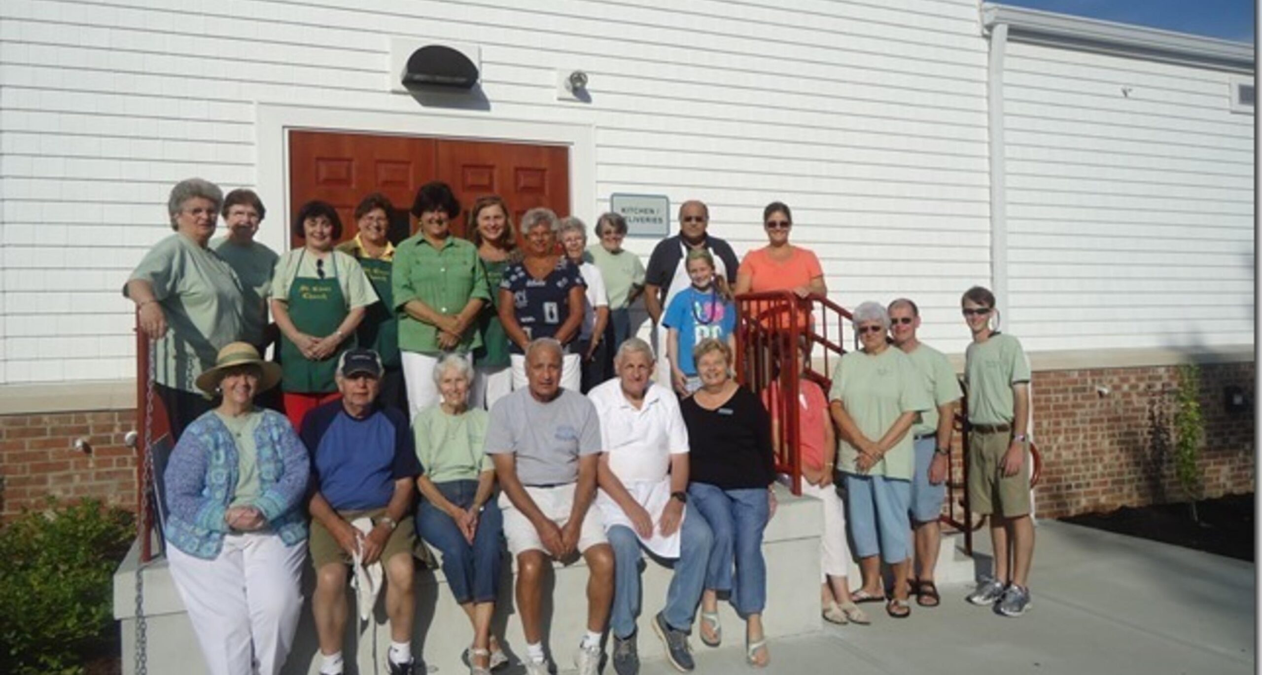 Large group of volunteers outside the church
