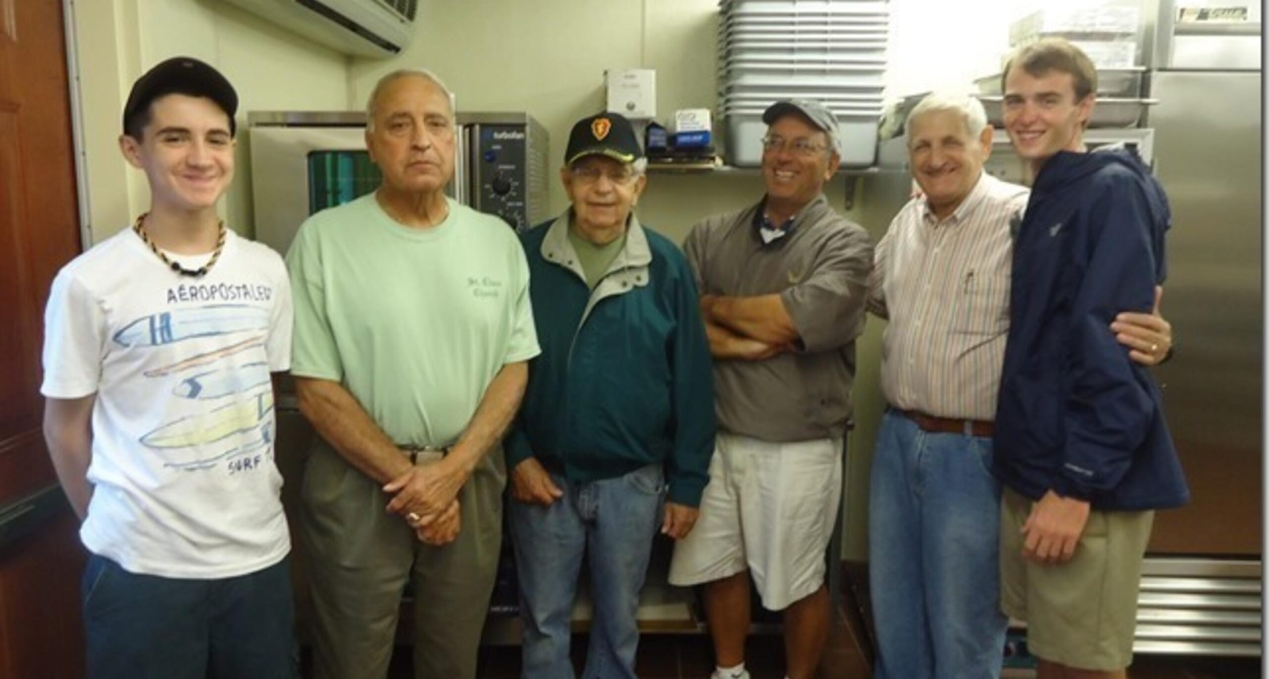 Group of men standing together indoors