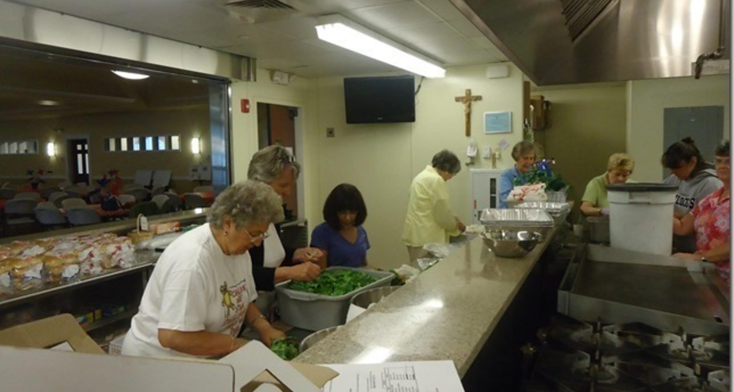 Volunteers preparing food in the parish kitchen