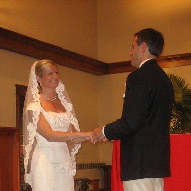 Bride and groom holding hands at the altar